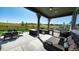 Outdoor kitchen area with grill, seating, and covered patio at 26994 E Indore Ave, Aurora, CO 80016