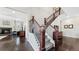 Elegant staircase with dark wood railings and gray carpeting at 26994 E Indore Ave, Aurora, CO 80016