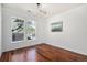 Bright, well-lit bedroom featuring hardwood floors, white walls, and large windows offering a pleasant view at 10184 Park Meadows Dr # 1102, Lone Tree, CO 80124