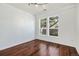 This well-lit bedroom features hardwood floors, white walls, and large windows offering a pleasant view at 10184 Park Meadows Dr # 1102, Lone Tree, CO 80124