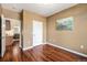 Bedroom with hardwood floors, access to the kitchen and attached bath, and a calming wall painting at 10184 Park Meadows Dr # 1102, Lone Tree, CO 80124