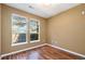 This bedroom has warm-toned walls, hardwood floors, and a large window offering a pleasant view at 10184 Park Meadows Dr # 1102, Lone Tree, CO 80124