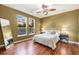 A serene bedroom features a ceiling fan, windows, and decor for comfortable living at 10184 Park Meadows Dr # 1102, Lone Tree, CO 80124