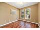 This bedroom features warm-toned walls, hardwood floors, a large window and an art piece at 10184 Park Meadows Dr # 1102, Lone Tree, CO 80124