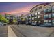 Apartment building exterior at sunset with brick accents and balconies at 10184 Park Meadows Dr # 1102, Lone Tree, CO 80124