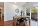 Bright dining room with wood table and modern decor, bathed in natural light from the sliding glass doors at 10184 Park Meadows Dr # 1102, Lone Tree, CO 80124