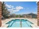 Inviting hot tub area with chairs, surrounded by landscaping and partial community views at 10184 Park Meadows Dr # 1102, Lone Tree, CO 80124