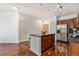 Bright kitchen features stainless steel appliances, a center island, and elegant dark wood cabinets and flooring at 10184 Park Meadows Dr # 1102, Lone Tree, CO 80124