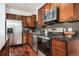 The kitchen features stainless steel appliances, granite countertops, and beautiful dark wood cabinets and flooring at 10184 Park Meadows Dr # 1102, Lone Tree, CO 80124