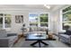 Bright living room featuring hardwood floors, a comfortable sofa, and views from the windows at 10184 Park Meadows Dr # 1102, Lone Tree, CO 80124