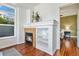Cozy living room with fireplace and custom shelving, showcasing hardwood floors and bright light at 10184 Park Meadows Dr # 1102, Lone Tree, CO 80124