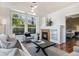 Bright living room with fireplace, hardwood floors, and a glimpse of the bedroom at 10184 Park Meadows Dr # 1102, Lone Tree, CO 80124