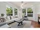 Bright living room with hardwood floors, large windows and comfortable seating at 10184 Park Meadows Dr # 1102, Lone Tree, CO 80124