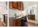 A charming office space with built-in desk and cabinetry features a view into the bathroom at 10184 Park Meadows Dr # 1102, Lone Tree, CO 80124