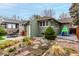 Spacious backyard featuring vibrant greenery and a play area at 2664 Dahlia St, Denver, CO 80207