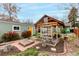 Well-maintained backyard with a greenhouse and outdoor shed at 2664 Dahlia St, Denver, CO 80207