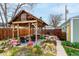 Relaxing backyard featuring a pergola with outdoor seating and garden at 2664 Dahlia St, Denver, CO 80207