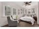 Cozy bedroom featuring multiple windows and a comfortable sitting area at 2664 Dahlia St, Denver, CO 80207