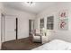 Bright bedroom featuring a sitting area and closet at 2664 Dahlia St, Denver, CO 80207