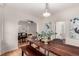Dining room featuring a large wooden table, modern chairs and an open floorplan at 2664 Dahlia St, Denver, CO 80207