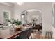 Dining room featuring a large wooden table, modern chairs, and open layout at 2664 Dahlia St, Denver, CO 80207