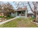 Charming single story home with a cozy front porch, walkway and lush lawn at 2664 Dahlia St, Denver, CO 80207