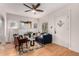 Inviting living room featuring hardwood floors, ceiling fan, and cozy seating at 2664 Dahlia St, Denver, CO 80207