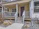 Inviting front porch with decorative string lights and fresh gravel, enhancing curb appeal at 2892 S Fox Ct, Englewood, CO 80110