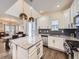 Modern kitchen featuring an island with granite countertops, stainless steel appliances, and stylish lighting fixtures at 2892 S Fox Ct, Englewood, CO 80110