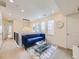 Stylish loft with a comfortable blue sofa, modern glass coffee table, and natural light from the windows at 2892 S Fox Ct, Englewood, CO 80110