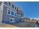 Large backyard featuring a two-story house with a deck and a fence at 9592 Keystone Trl, Parker, CO 80134