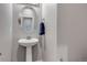 Powder room featuring a pedestal sink, oval mirror, and neutral color palette at 9592 Keystone Trl, Parker, CO 80134