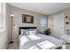 Sunlit bedroom with a bed and a view, featuring a decorative poster at 9592 Keystone Trl, Parker, CO 80134