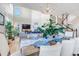 Open dining and living area with hardwood floors, a chandelier, and access to stairs leading upstairs at 9592 Keystone Trl, Parker, CO 80134