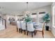 Elegant dining room with a chandelier, wooden table, and upholstered chairs, next to the kitchen at 9592 Keystone Trl, Parker, CO 80134