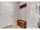 Functional entryway with a coat rack, bench, and storage drawers at 9592 Keystone Trl, Parker, CO 80134