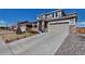 Charming two-story home with a stone facade and a large driveway, complemented by a well-maintained lawn at 9592 Keystone Trl, Parker, CO 80134