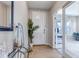 Inviting foyer with hardwood floors, a glass table, a mirror, and a decorative plant, bathed in soft natural light at 9592 Keystone Trl, Parker, CO 80134