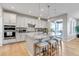 Modern kitchen featuring a large island with seating, pendant lights, and stainless steel appliances at 9592 Keystone Trl, Parker, CO 80134