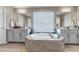 Luxurious main bathroom with a large soaking tub, dual vanities, and ample lighting at 9592 Keystone Trl, Parker, CO 80134