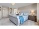 Comfortable main bedroom with a tufted headboard, chandelier, and neutral decor at 9592 Keystone Trl, Parker, CO 80134