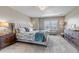 Spacious main bedroom with a large window, neutral walls, and stylish furnishings at 9592 Keystone Trl, Parker, CO 80134