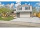 Charming two-story home with brick accents, a spacious driveway, and a well-manicured lawn at 4924 S Flower Way, Littleton, CO 80123