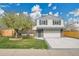 Charming two-story home with brick accents, a spacious driveway, and a well-manicured lawn at 4924 S Flower Way, Littleton, CO 80123