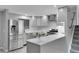 Modern kitchen featuring stainless steel appliances, granite countertops, and white subway tile backsplash at 4924 S Flower Way, Littleton, CO 80123