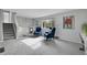 Living room featuring plush armchairs, gray carpet, and a sun-filled window at 4924 S Flower Way, Littleton, CO 80123