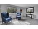 Bright and airy living room featuring plush armchairs, gray carpet, and a console table at 4924 S Flower Way, Littleton, CO 80123