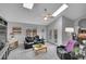 Bright living room with skylights, comfortable seating, and access to the backyard at 4924 S Flower Way, Littleton, CO 80123