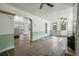 Spacious room with wood floors, archways, light green wainscoting and natural light at 710 6Th St, Georgetown, CO 80444