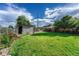 Well-maintained backyard with green grass and colorful flowers, perfect for outdoor entertaining at 3090 W Longfellow Pl, Denver, CO 80221